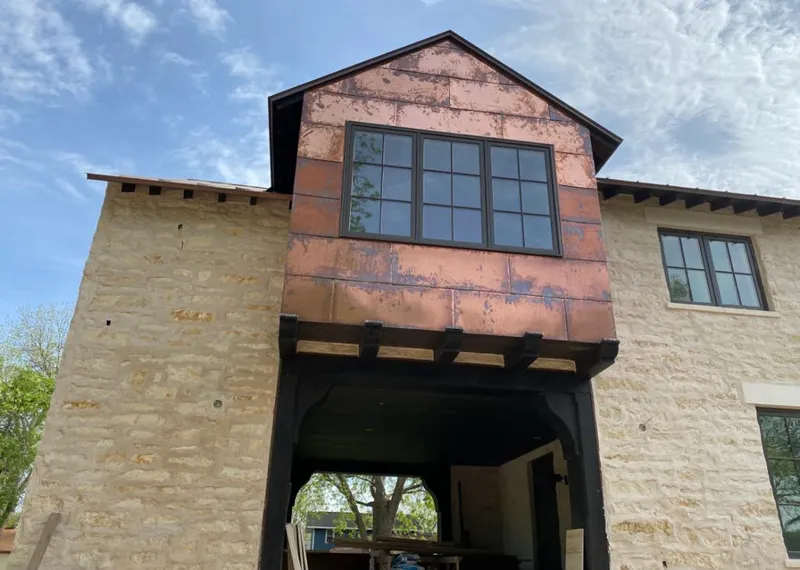 Copper metal panel facade on a stone building for Skylight Installation in Westmont